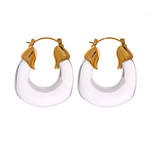 Une paire sur fond blanc de boucles créole de couleur transparente avec à leurs bout un fermoir à bascule en or